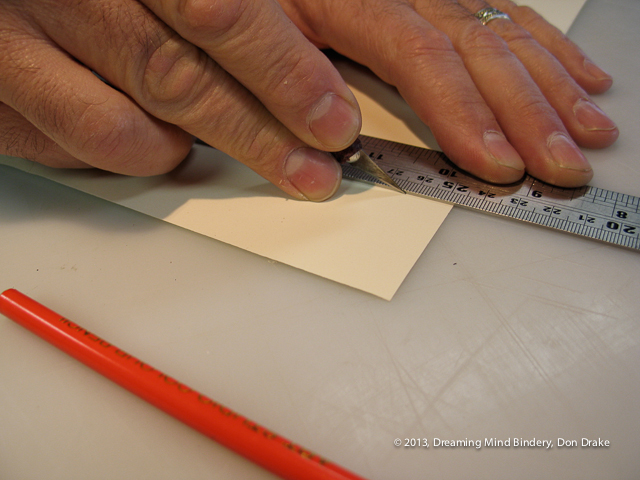 A close showing good technique in the use of a knife when cutting paper