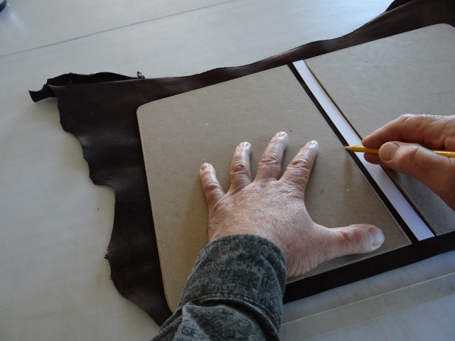 Laying out the cover inside a goat skin