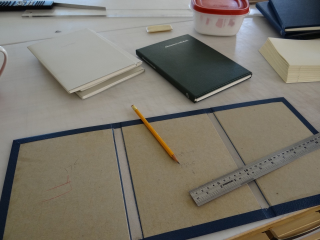 Double checking measurements before cutting boards for a production run of the three book in The Conversation Series, a collaboration between Kate Jordahl and Don Drake