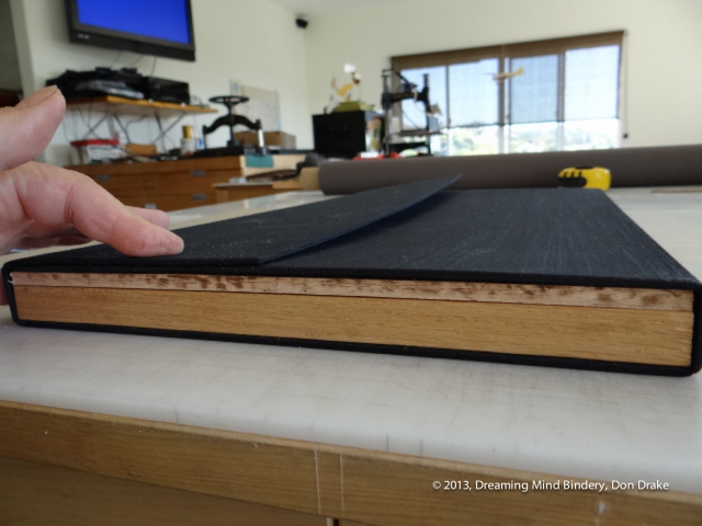 Verifying the fit of the rough cut wooden components in the partially completed case of the box