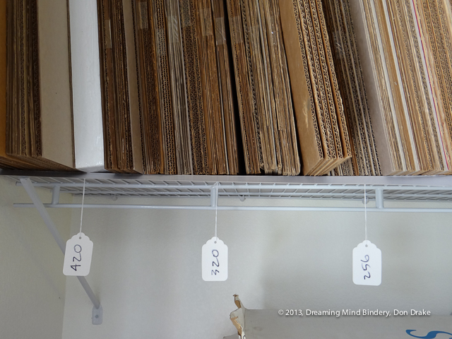 A shelf full of filler boards for clamshell box construction