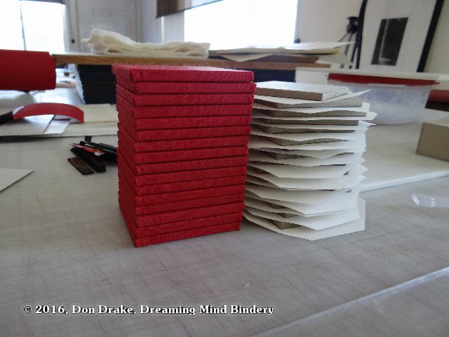 Red and white covered panels for the content portion of Partially finished boxes for Don Drake's edition 'Global Warming Survival Kit'