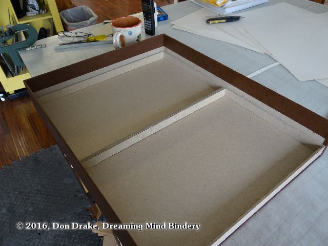 Partially completed trays being test-fit inside a clamshell box