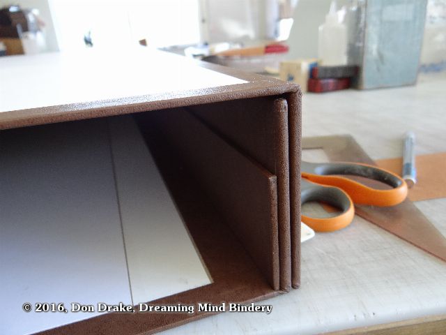 dry fitting the base and lid shells of a clamshell box. Also shown is a rail on the inside of the base shell for the support of trays.