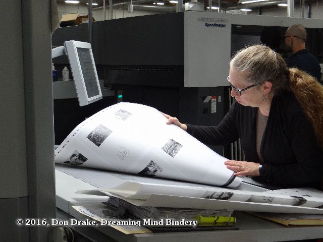 Kate Jordahl checking a press sheet for the One Poem Books #5 & 6