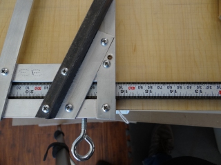 The scale and stop on a board shear