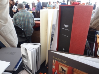 A finished copy of Luis Delgado's Cuentos Chinos displayed on his Malulu table at the 2013 Codex in the Craneway Pavillion, Richmond, CA