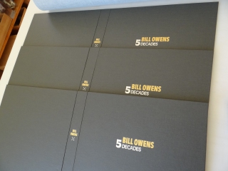 The final 3 Bill Owens 5 Decades boxes stamped with the portfolio tile on the spine and cover